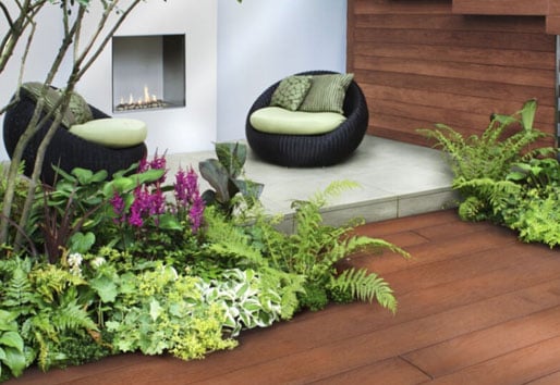 outdoor space with greenery and two chairs