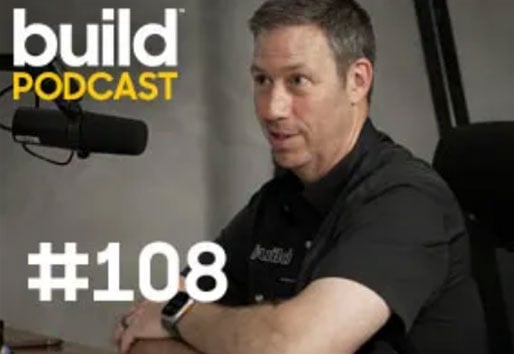 man sitting with microphone doing a podcast