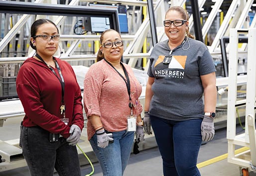 3 andersen employees in front of machines