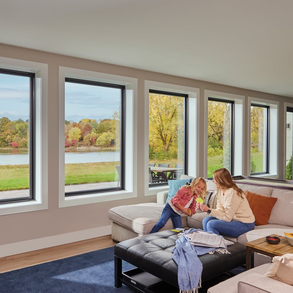 Young girl and mom in basement with large windows