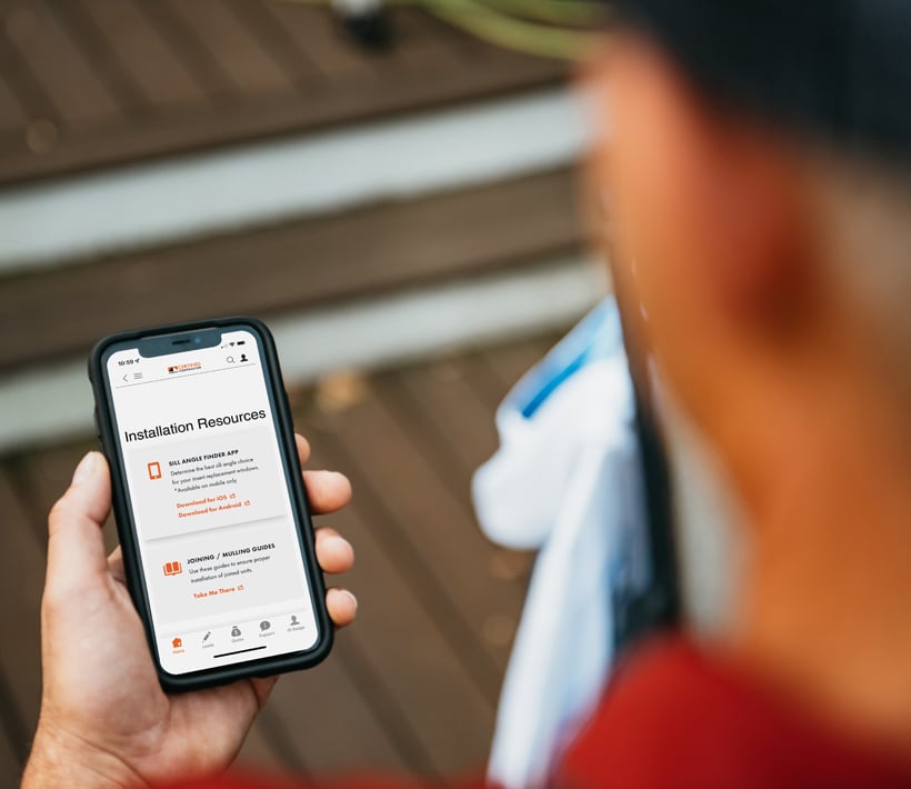 person holding iphone with andersen certified contractor page on screen