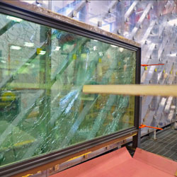 testing being done on window with board penetrating glass