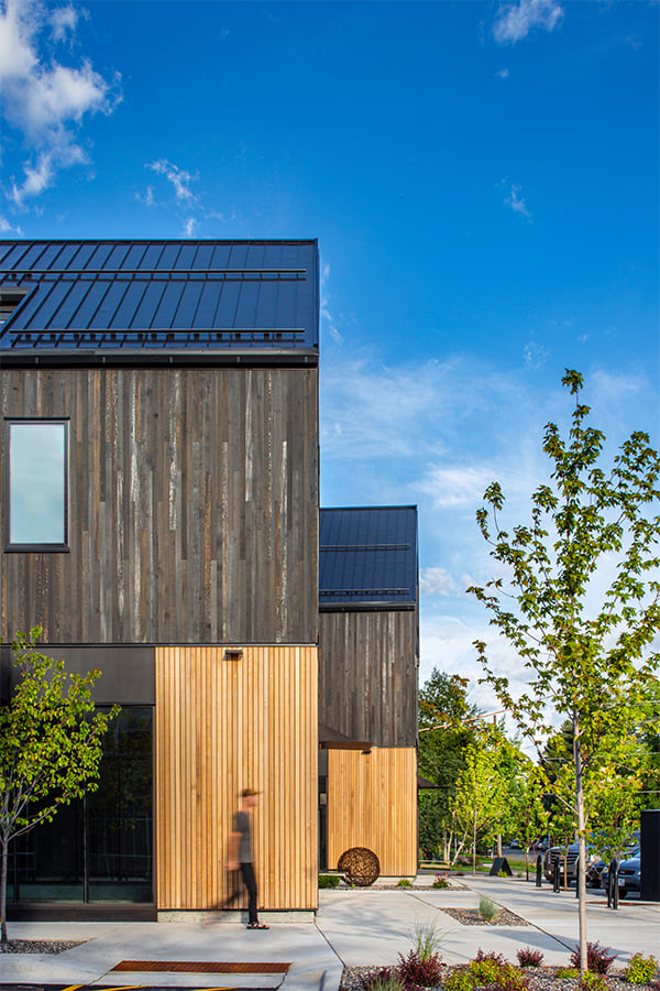 A view of a cedar-clad building seen from the side. 