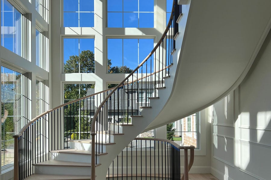 Spiral staircase with floor to ceiling windows with grilles