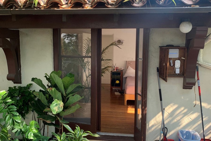 An after photo of a new E-Series Hinged Patio door, on the left, and a before picture of the same opening with the old French door, on the right.
