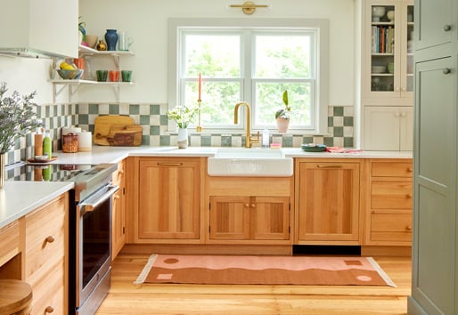 A bright kitchen with white walls, 200 Series double-hung windows, wood cabinets, and green accents. 