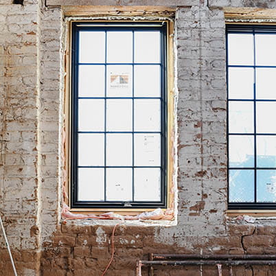 black framed windows on vintage brick