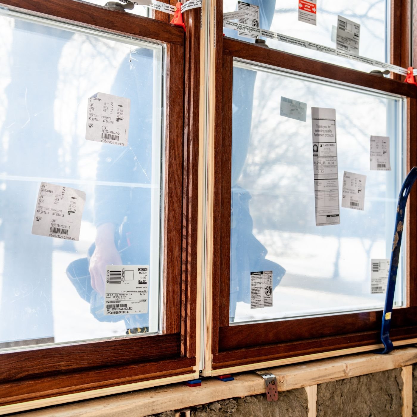 A close up shot of a newly installed window with Andersen stickers.