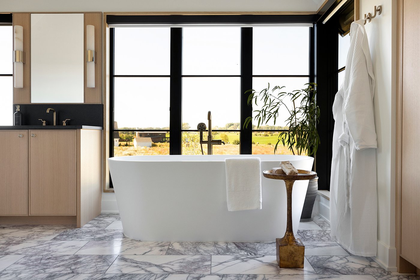 A soaking tub with prairie views out the floor-to-ceiling windows.