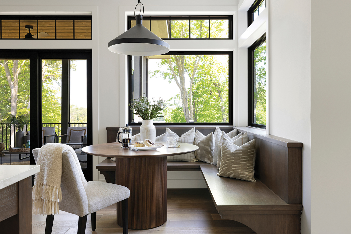 100 Series Picture Windows create a corner window effect in this breakfast nook. The transoms above the windows further the traditional charm of this space.