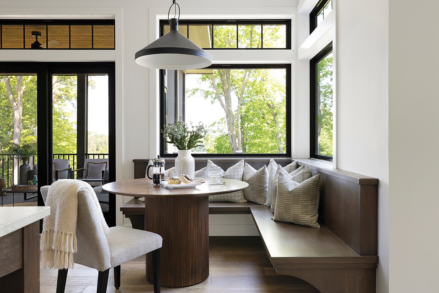 100 Series Picture Windows create a corner window effect in this breakfast nook. The transoms above the windows further the traditional charm of this space.