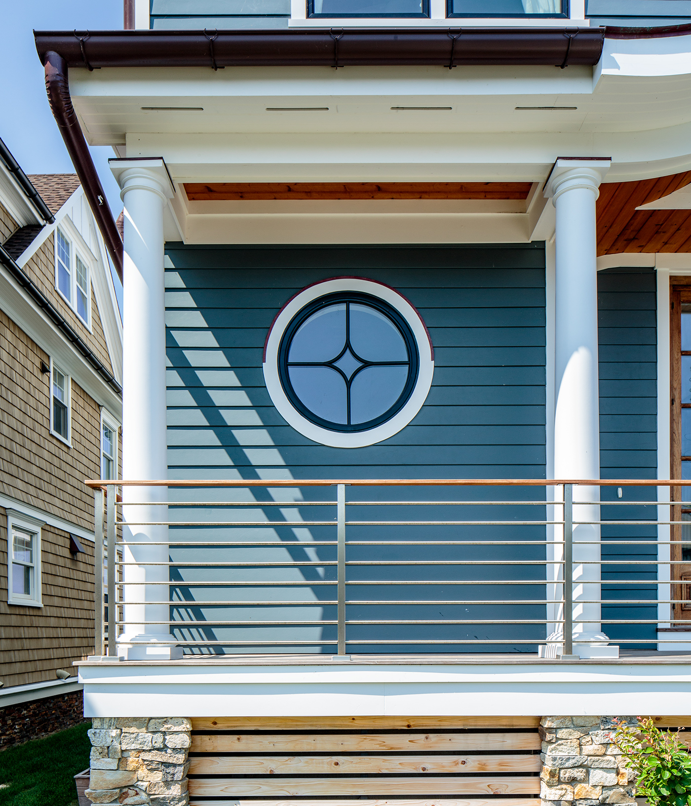 A traditional home with an Andersen® 400 Series Specialty Window in a circle shape.