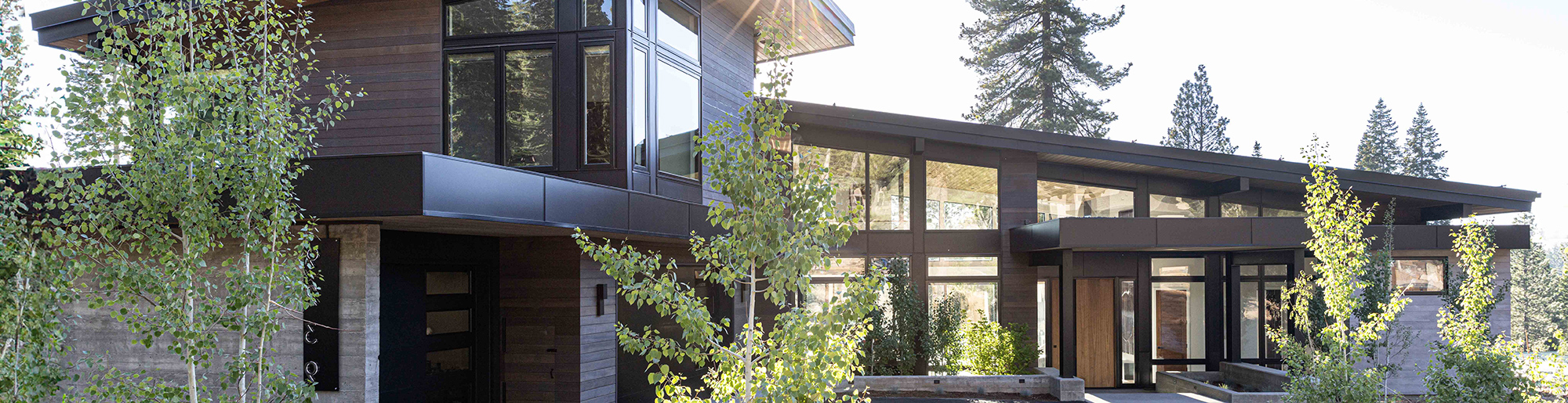 Modern style home with low pitch roof and an abundance of windows