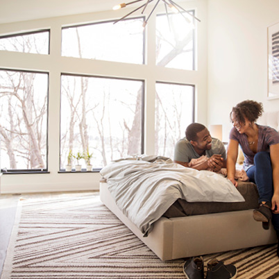 livingroom with fullview black framed andersen windows looking out to pool