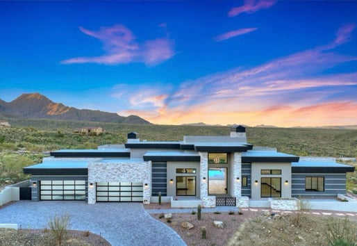 A luxury desert home rendering at sunset with a contemporary design and expansive views created by black Andersen® Aluminum Multi-Slide Doors and 100 Series Gliding and Picture Windows.