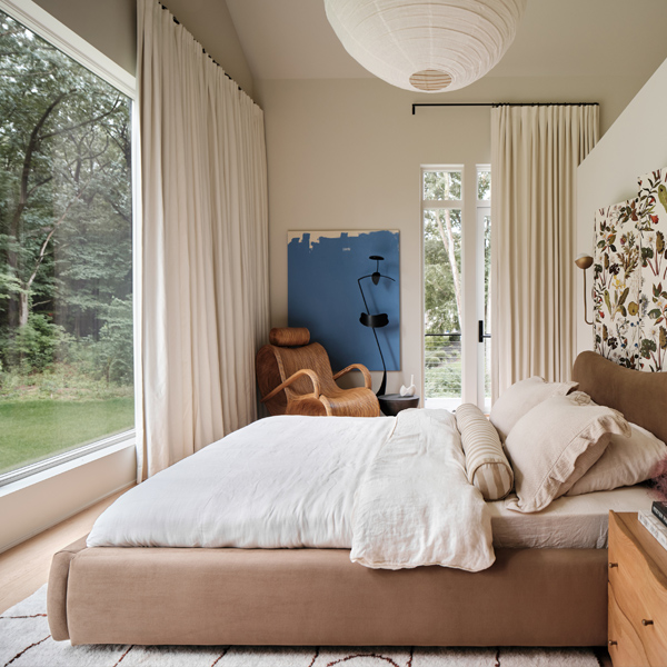 Bedroom with large picture windows and floral headboard