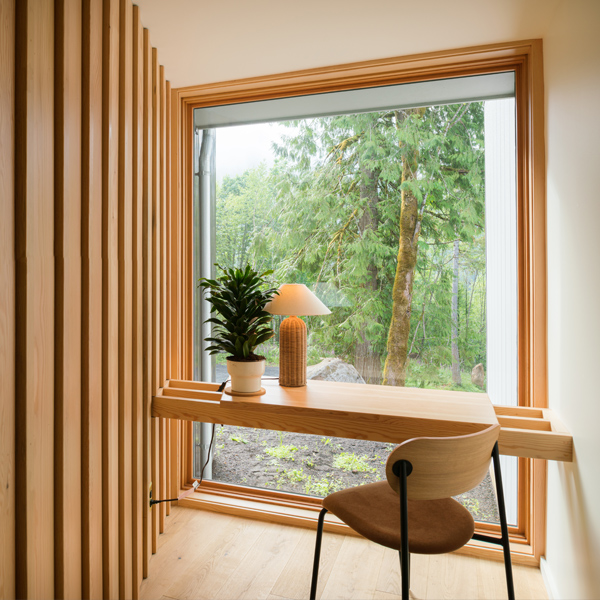 retro modern office set in front of a large picture window overlooking nature
