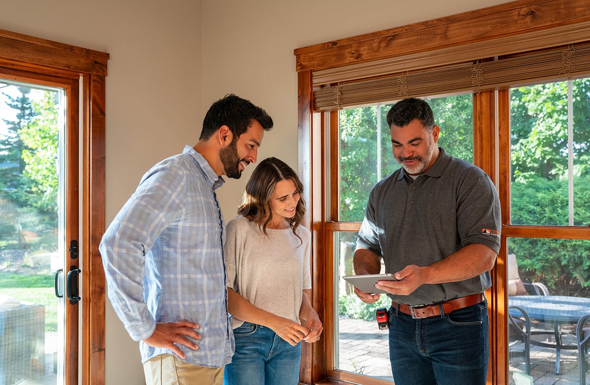 Contractor showing clients something on an iPad