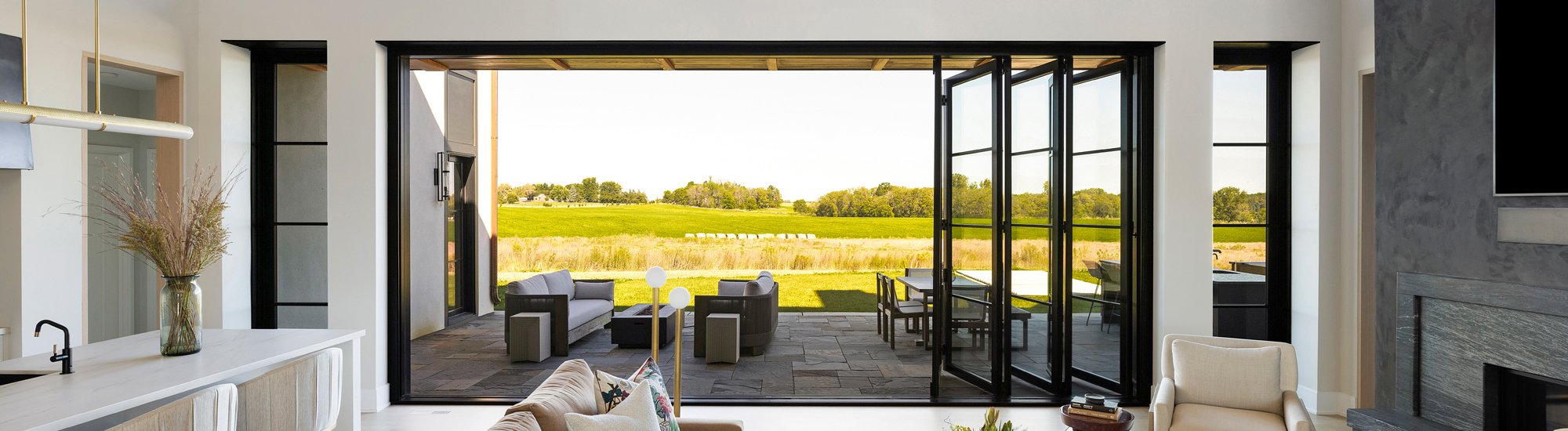 Large folding outswing doors opening up to a beautiful outdoor view