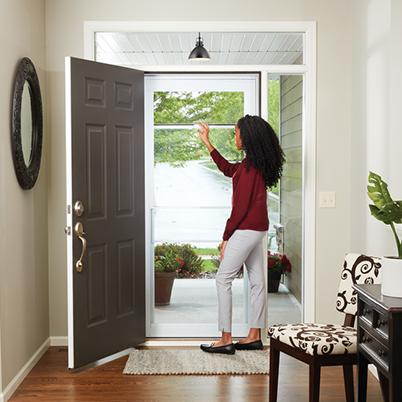 storm door and woman opening the screen
