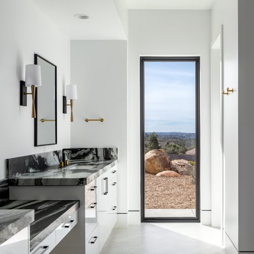 Tall window in bathroom overlooking beautiful landscapes