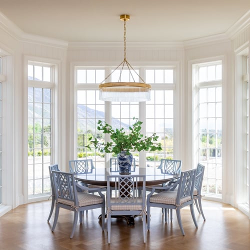 White dining room with tall windows with grilles