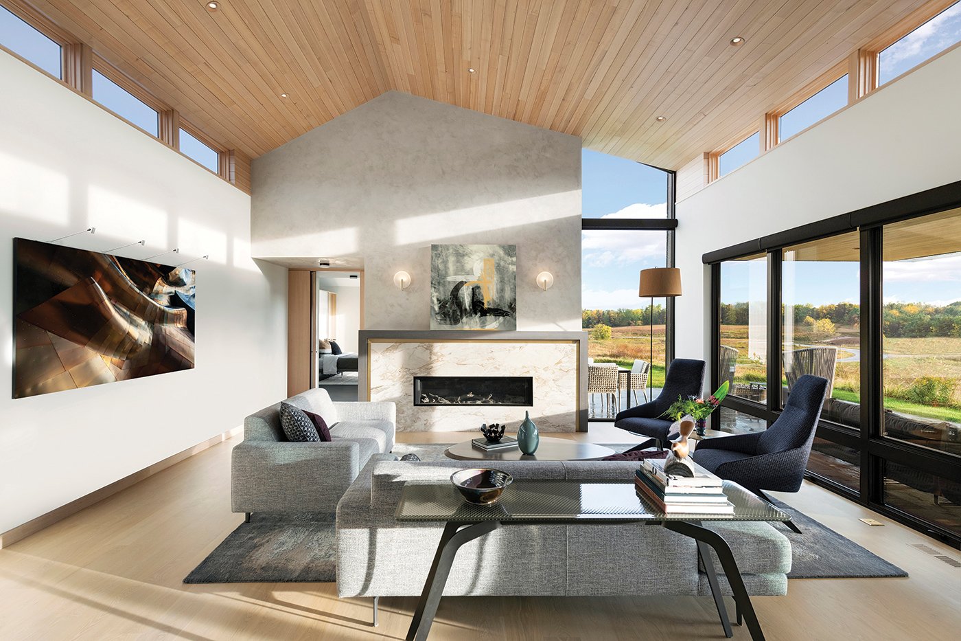A living room with clerestory windows on both sides and floor-to-ceiling windows facing the backyard.