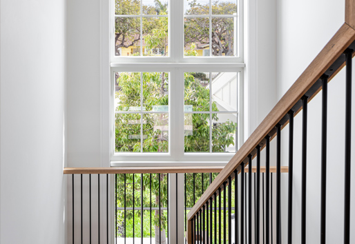 Stairway with floor to ceiling windows with vaulted ceilings