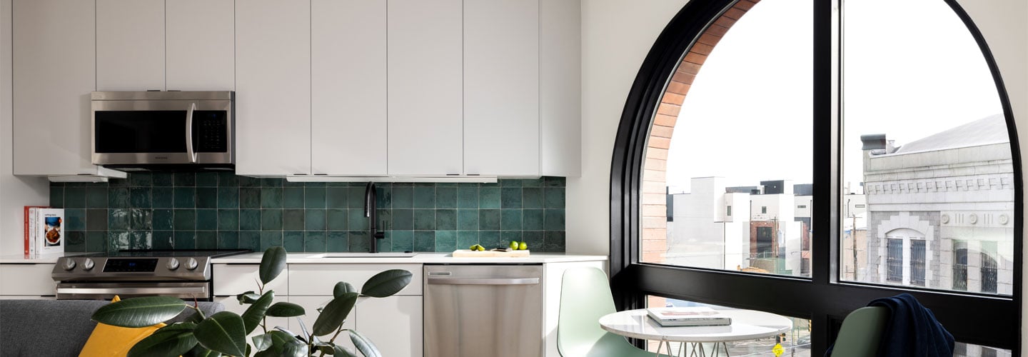 An apartment with a large arched window combination unit made of Andersen® E-Series Specialty Windows.