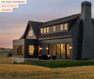 two story home at night with andersen windows