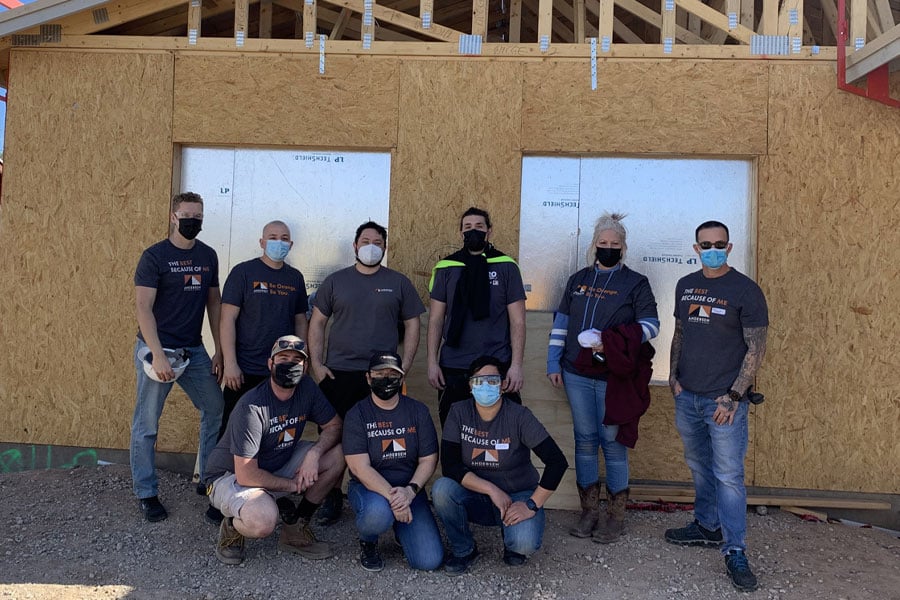 Goodyear team posing in front of construction for habitat for humanity of central Arizona 