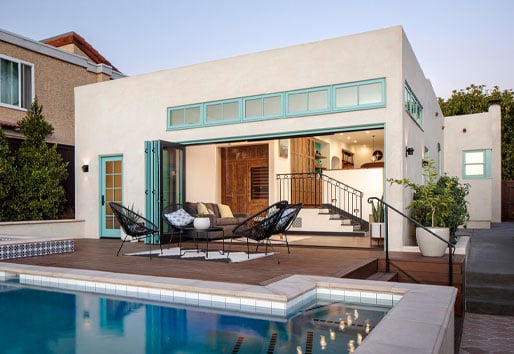 exterior of modern home with pool and blue framed andersen windows