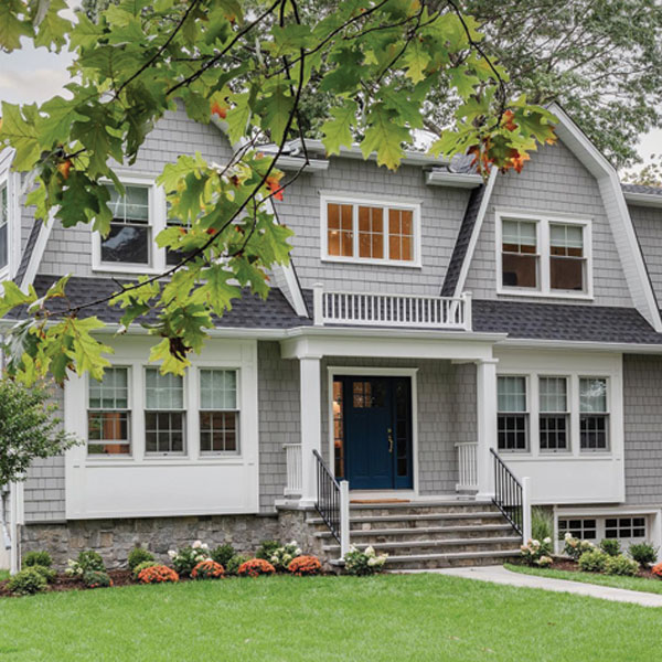 tradition gray house with andersen white framed windows
