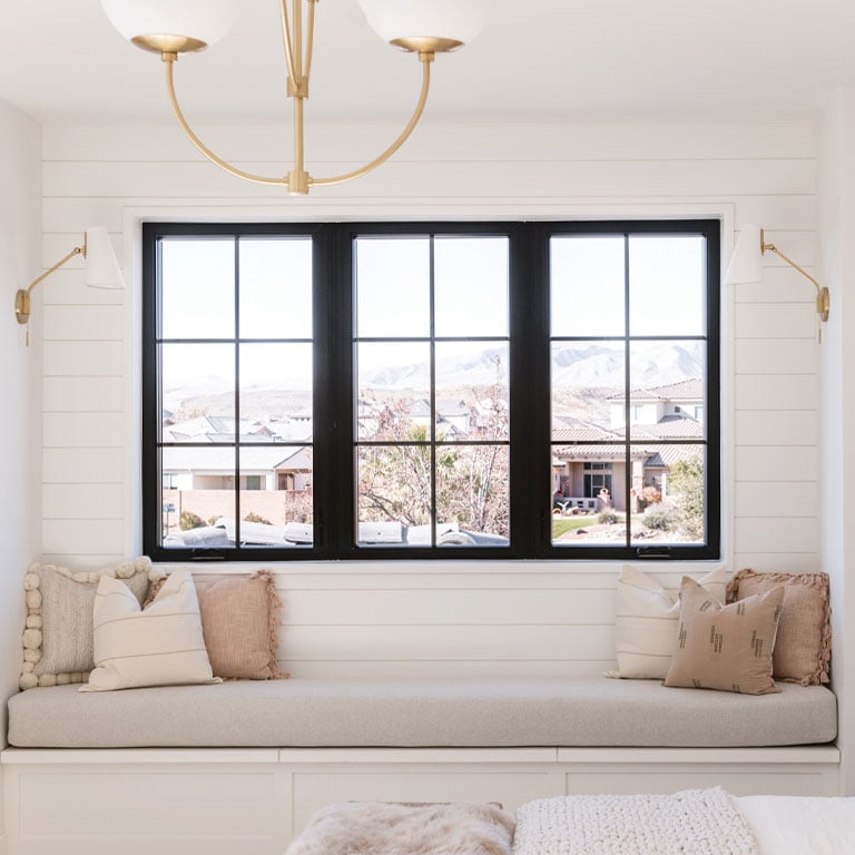 sitting area with white accents and black framed window