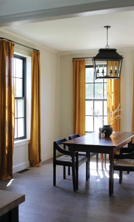 traditional grilles in dining room with black framed windows