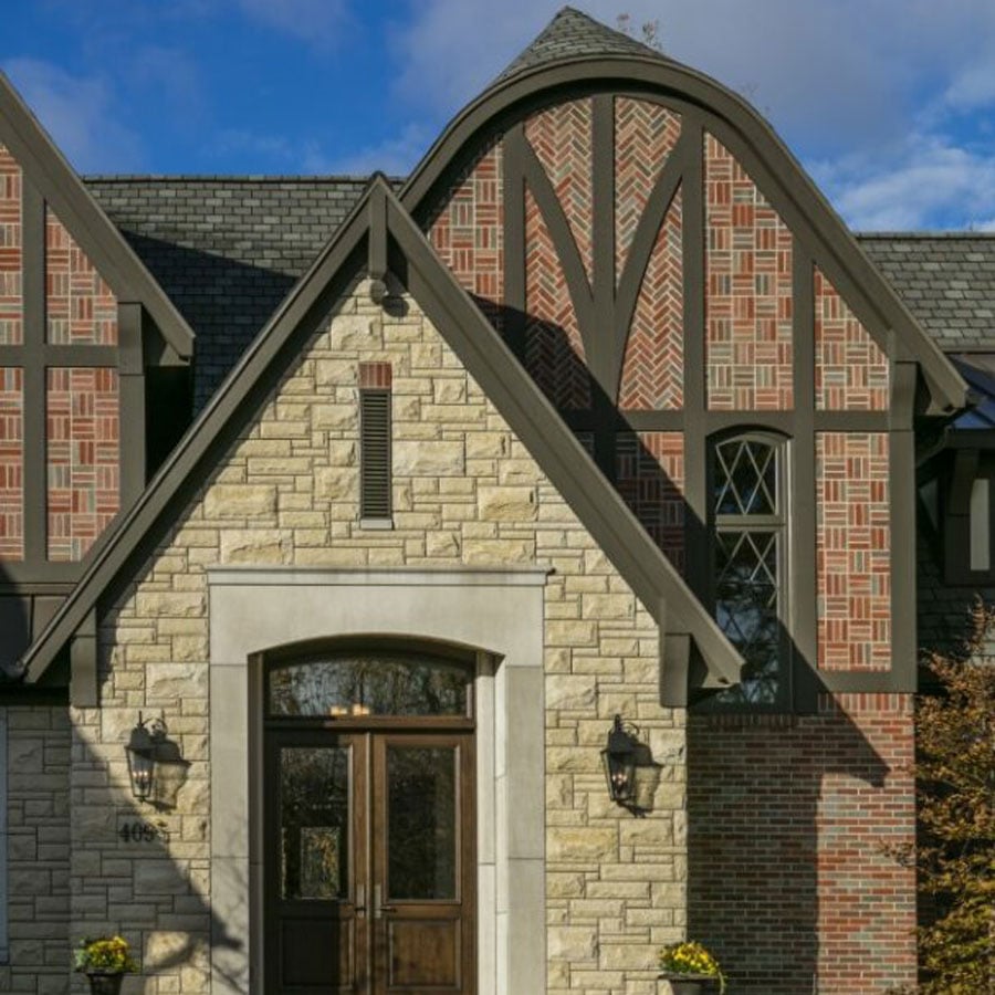 Grand Rapids, Michigan stone classic home. E-Series: casement, picture, single & double-hung and specialty windows. Gliding patio door and French hinged patio door.