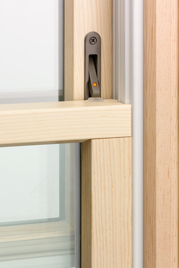 A rendering showing a section of a 400 Series Double-Hung Window whose opening is controlled by built-in hardware applied at the factory.
