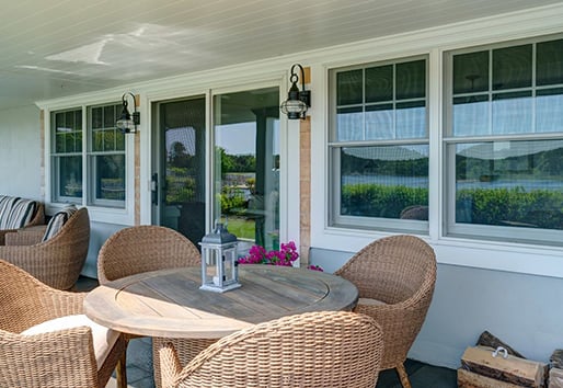 cozy outdoor patio showing home with Andersen windows