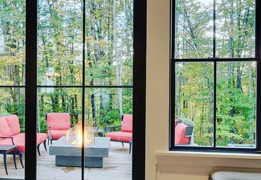 Andersen window view to outdoor patio and bonfire