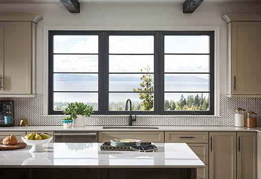 better homes and gardens article thumbnail: kitchen with three windows over sink