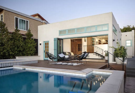 exterior view of white modern home with pool with Andersen big doors