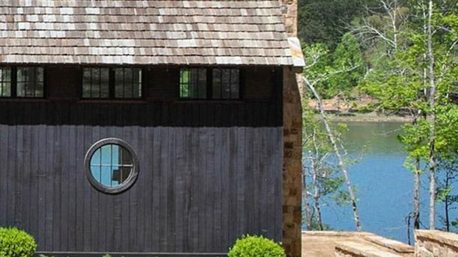 exterior image of cabin by lake with Andersen circle window