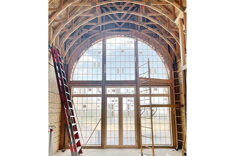 Emily Jackson project in progress featuring Andersen E Series windows and doors to create arched wall of windows