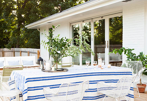 An outdoor meal on the sunny deck is made easy thanks to the folding outswing doors connecting to the kitchen inside
