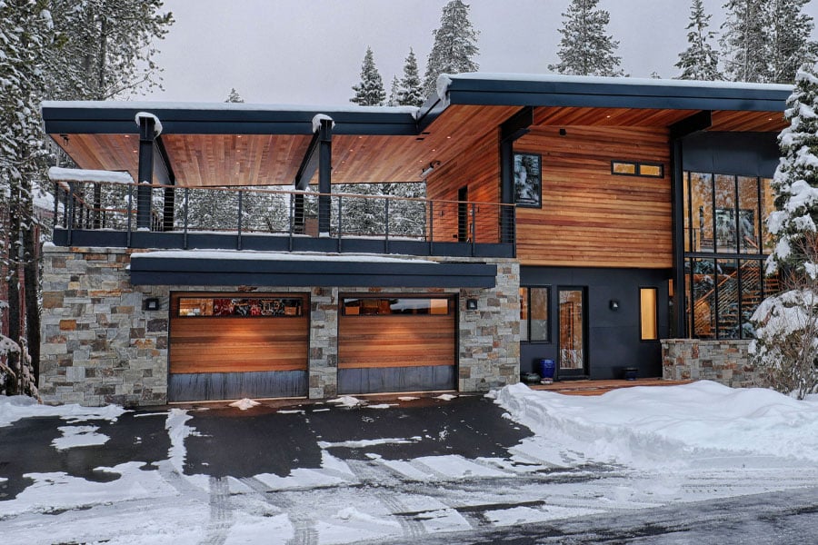 house in winter with wood siding