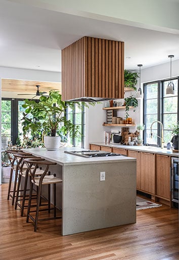 Hilton Carter renovated, modern kitchen with concrete, wood, and black windows