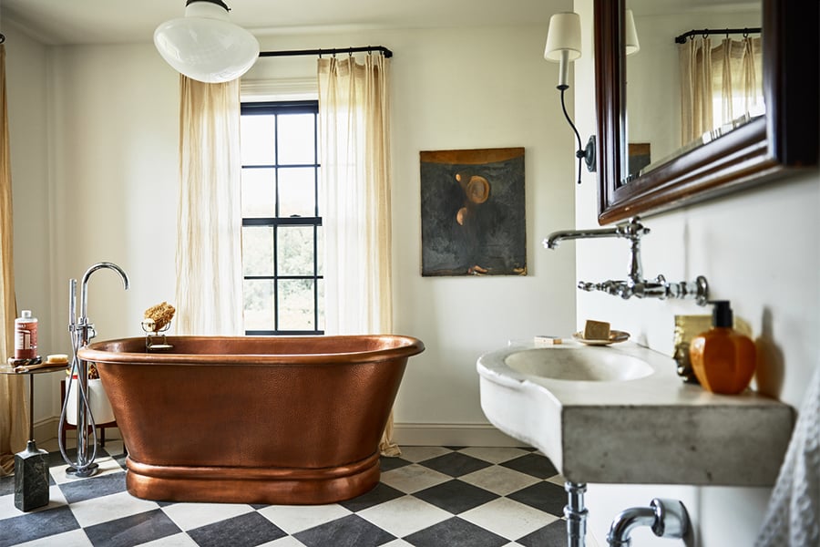 bathroom with copper tub and checkered tile