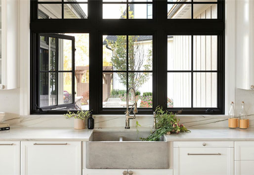 A double row of black casement windows above a kitchen sink.