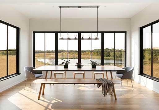 White Oaks Savanna Community, dining room of home in prairie with black windows