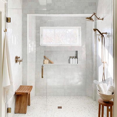 Marble bathroom with walk-in shower and awning window